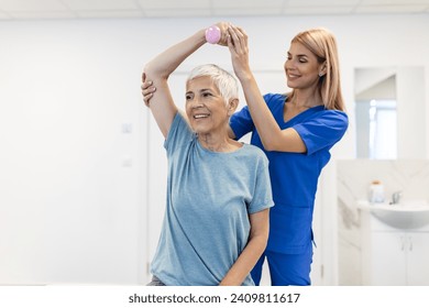 Physiotherapist woman giving exercise with dumbbell treatment About Arm and Shoulder of senior female patient Physical therapy concept - Powered by Shutterstock