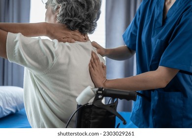 Physiotherapist working with asian elderly female patient woman having chiropractic back adjustment. Osteopathy, in clinic - Powered by Shutterstock