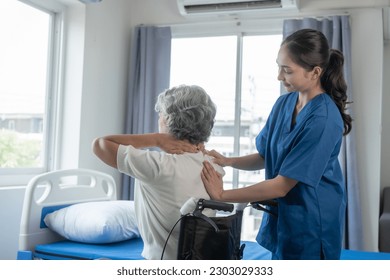 Physiotherapist working with asian elderly female patient woman having chiropractic back adjustment. Osteopathy, in clinic - Powered by Shutterstock