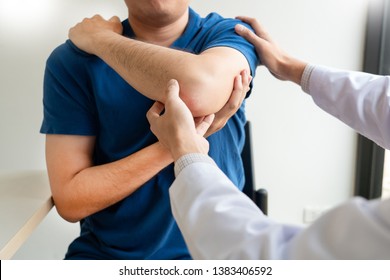 Physiotherapist working concept, Doctor and patient suffering or Chiropractor examining from shoulder pain in clinic medical office - Powered by Shutterstock