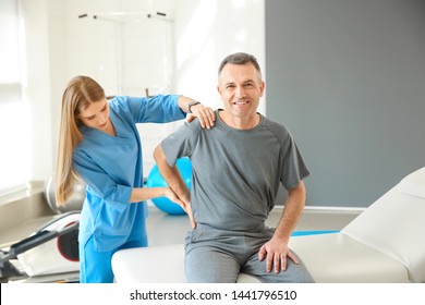 Physiotherapist Working With Mature Patient In Rehabilitation Center