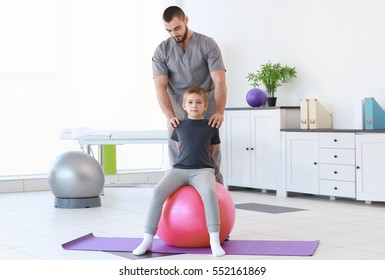 Physiotherapist Working With Patient In Clinic