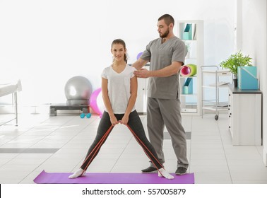 Physiotherapist Working With Patient In Clinic