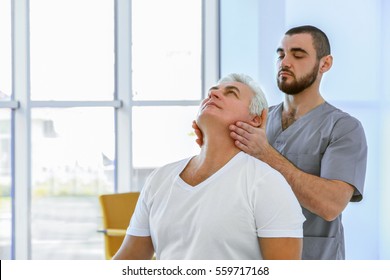 Physiotherapist working with patient in clinic - Powered by Shutterstock