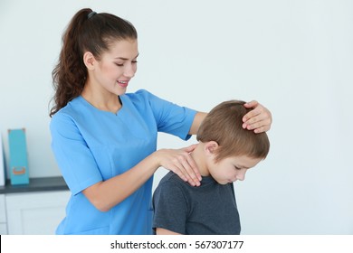 Physiotherapist working with patient in clinic - Powered by Shutterstock