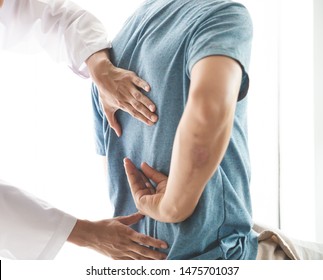 Physiotherapist working with patient in clinic, closeup - Powered by Shutterstock