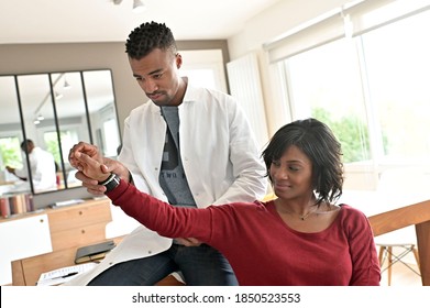 Physiotherapist working with patient in clinic office
