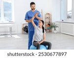 Physiotherapist working with patient in rehabilitation center