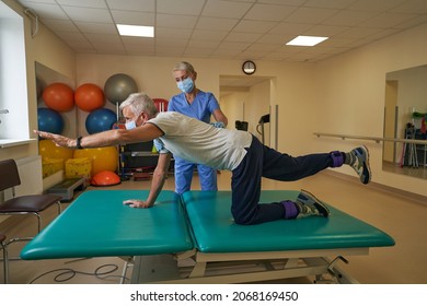 Physiotherapist Works With Stroke Patient In Clinic