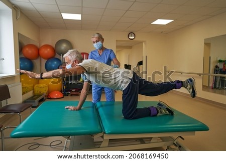 Physiotherapist works with stroke patient in clinic