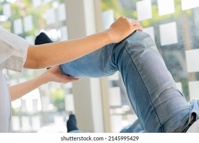 Physiotherapy Concept Image Of A Young Man With Injured Leg Giving Doctor Massage Patient Leg Giving Medical Treatment For Sprained Ligament The Concept Of Rehabilitation After A Leg Injury.