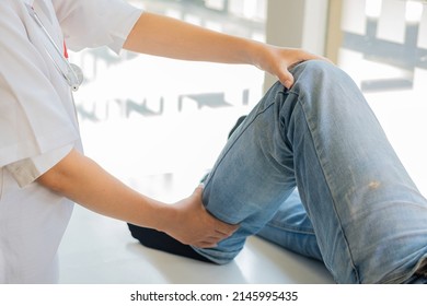 Physiotherapy Concept Image Of A Young Man With Injured Leg Giving Doctor Massage Patient Leg Giving Medical Treatment For Sprained Ligament The Concept Of Rehabilitation After A Leg Injury.