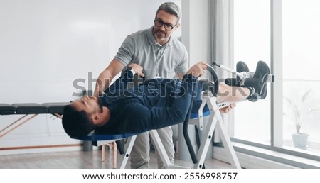 Physiotherapy, consulting and inversion table with man in clinic for back pain, spine decompression and core strength. Rehabilitation, health and advice with people for chiropractor, help and healing