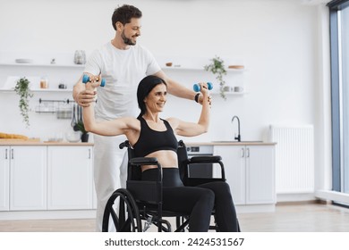 Physiotherapy healthcare, medical doctor consulting disabled caucasian patient. Trainer or husband helping mature woman in wheelchair lifting arms with dumbbells for muscle strength in rehabilitation. - Powered by Shutterstock