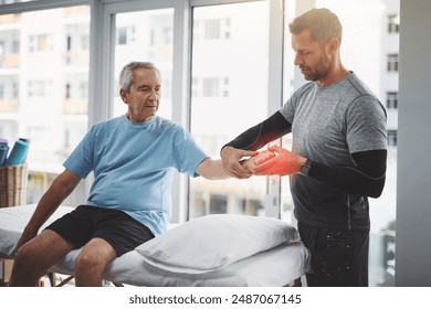 Physiotherapy, wrist pain and man with senior patient for orthopedic care, consulting and wellness. Chiropractor, healthcare and physical therapist with person for rehabilitation, support and healing - Powered by Shutterstock