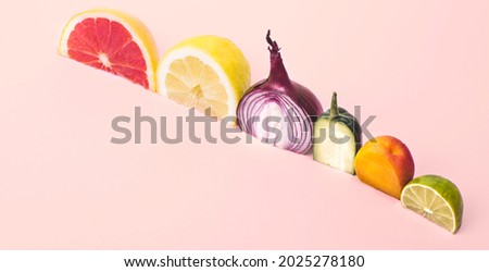 Phytonutrients (fitonutrients). Conceptual creative still life with halves of fruits and vegetables: cucumber, onion, lemon, lime, grapefruit, apricot, rich in phytonutrients and antioxidants. Banner