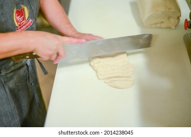 PIACENZA, ITALY - Jul 17, 2021: Woman Making Pisarei,  Tradtional Pasta , Extruded Fresh Pasta, Made Of Bread Crumbs, Water, Soft Wheat Four Type 00, Salt 