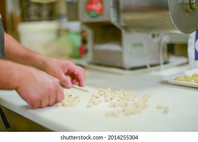 PIACENZA, ITALY - Jul 17, 2021: Woman Making Pisarei,  Tradtional Pasta , Extruded Fresh Pasta, Made Of Bread Crumbs, Water, Soft Wheat Four Type 00, Salt 