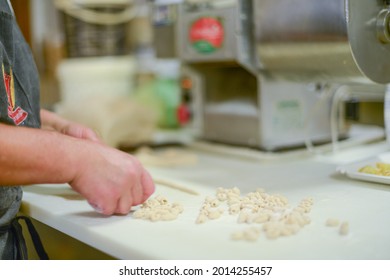 PIACENZA, ITALY - Jul 17, 2021: Woman Making Pisarei,  Tradtional Pasta , Extruded Fresh Pasta, Made Of Bread Crumbs, Water, Soft Wheat Four Type 00, Salt 