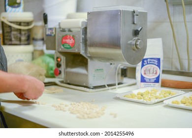 PIACENZA, ITALY - Jul 17, 2021: Woman Making Pisarei,  Tradtional Pasta , Extruded Fresh Pasta, Made Of Bread Crumbs, Water, Soft Wheat Four Type 00, Salt 