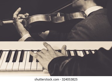 pianist & violinist jamming in classical live concert + vintage color filter for music background - Powered by Shutterstock