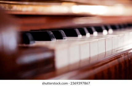 Piano keyboard background with selective focus. Warm colour toned image.The piano was set up in the music room by the windows in the morning to allow the pianist to rehearse before the classical piano - Powered by Shutterstock