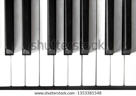 Piano keyboard with black and white on top view with light shadow.