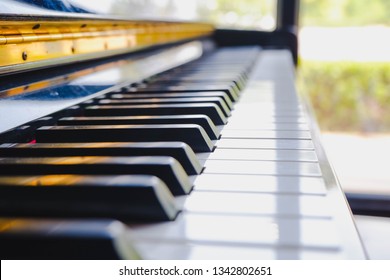 Piano keyboard in selective focus with warm tone in coffee shop  - Shutterstock ID 1342802651
