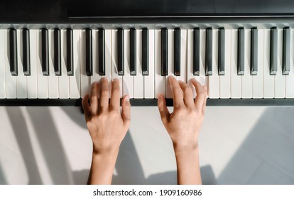 Piano Learning Chords At Home - Woman Playing Digital Keyboard With Online Music Lesson. Top View Of Musician Hands On Keys.