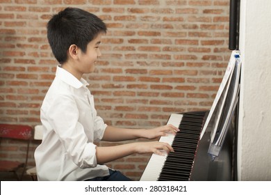 Piano Lesson, Asian Boy Kid Activity Playing Piano With Notes, Smiling