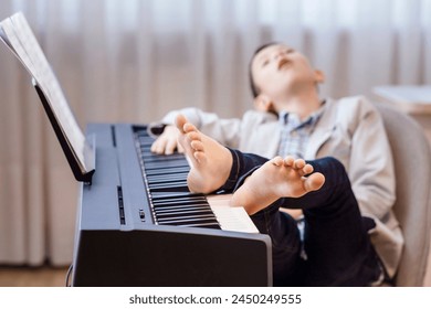 Piano Lessons. Tired Child Boy fell asleep Sleeping during Boring Piano Lessons. Learning Music Education.  - Powered by Shutterstock