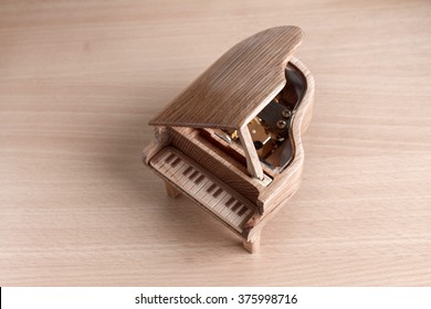 Piano Music Box On Wooden Background