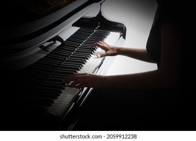 Piano player hands pianist playing keyboard. Grand piano keys. Classical music instruments closeup