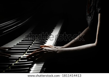 Piano player. Pianist hands playing grand piano keys. Music instrument keyboard