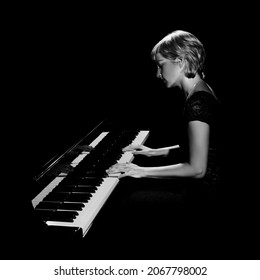 Piano Player. Pianist Woman Playing Grand Piano Concert. Classical Musician Isolated On Black Background