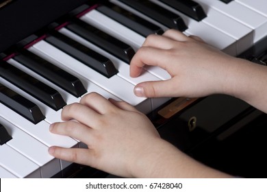Piano playing hands of a child