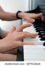 Piano Private Lesson. Young Woman Teaches A Kid To Play The Piano. Playing Together. Master Teaches A Boy To Play Piano. Concept Of The Music Study And Arts. Close-up. No Faces.