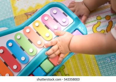 Piano Toy And Baby Hand