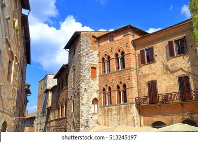 Piazza della Cisterna surrounded by medieval buildings in San Gimignano, region of Tuscany, Italy