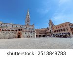 Piazza Grande in Modena on a sunny day with historic architecture and lively atmosphere