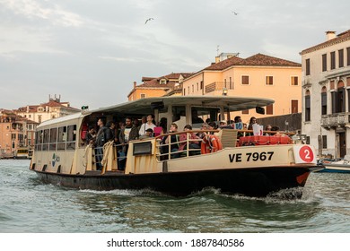 Piazza San Marco, Venezia, Italy - July 06, 2019: Tourists Enjoy The Ride On The Public Transport Boat (Vaporetto) On The Grand Canal In Venice, Italy.