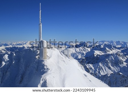 Pic du midi seen from the air on a sunny day with beautiful blue skies after several days of snowfal