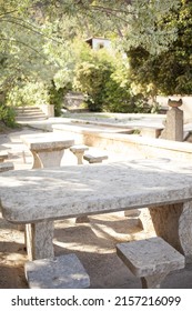 Pic Nic Spot Place With Big Stone Table And Seats Near Beach In Wild Nature Under Blooming Mimosa Trees In Spain