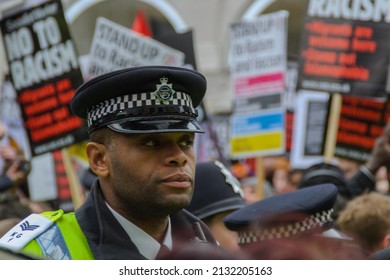 Piccadilly Circus, London UK - March 21st 2015: A Black Police Officer Among The Anti Racism Banners At The Stand Up To Racism And Fascism Demonstration.