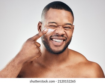 Pick Up A Good Moisturiser For Healthy Skin. Studio Portrait Of A Handsome Young Man Applying Moisturiser To His Face Against A White Background.