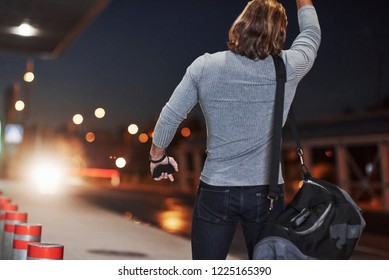 Pick me up please, I must be in airport right now. Young man with bag trying to stop the car because he's late. - Powered by Shutterstock