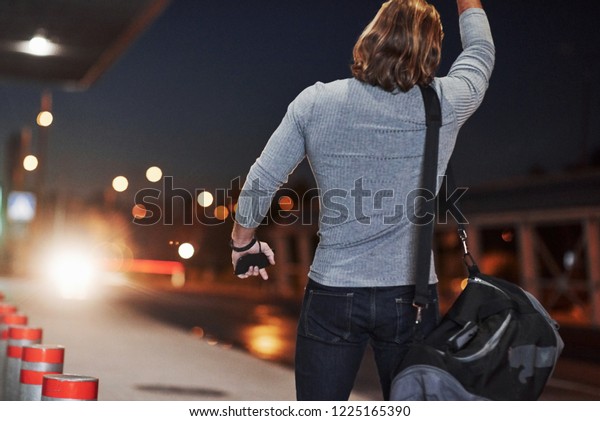 Pick me up\
please, I must be in airport right now. Young man with bag trying\
to stop the car because he\'s\
late.