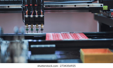 Pick and place robot machine assembling electronic circuit boards in factory