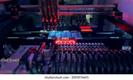 Pick and Place robot machine: SMD Assembly of electronic components on motherboard by an automated Pick and Place robot hand. Technology for SMD assemblage of chips with artificial intelligence. - Shutterstock ID 2093976691
