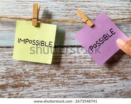 Pick possible instead of impossible with notepaper background. Stock photo.